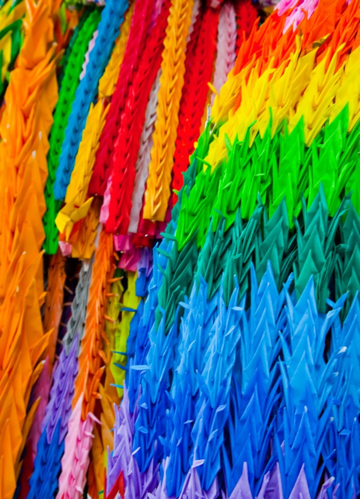 “Different coloured papers are used to create brilliant effects on these long strings of paper cranes