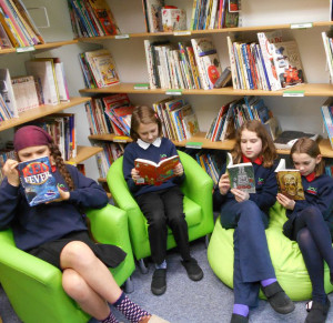 Pupils from Aldourie Primary reading Kelpies in their school library