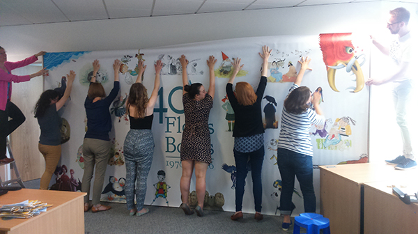 It's all hands on deck as the team work hard to install the "Great Wall of Floris Books"!