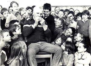 Photograph of Duncan Williamson playing music for children