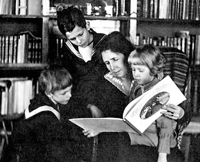 Photograph of Elsa Beskow, Swedish children's author and illustrator, reading a picture book with children