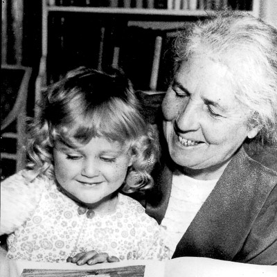 Photograph of Elsa Beskow, author of Swedish children's books, reading with a young child